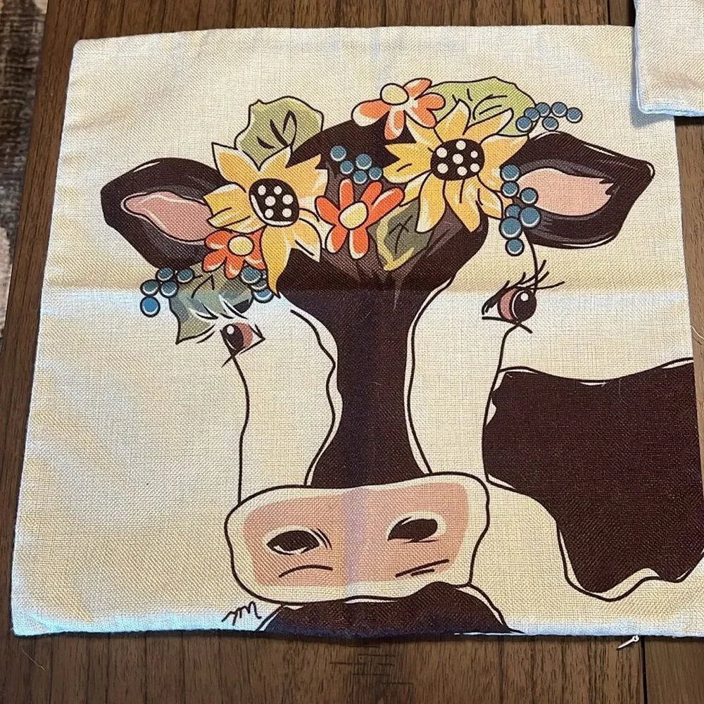 Decorated Pillow covers with cow and flowers.